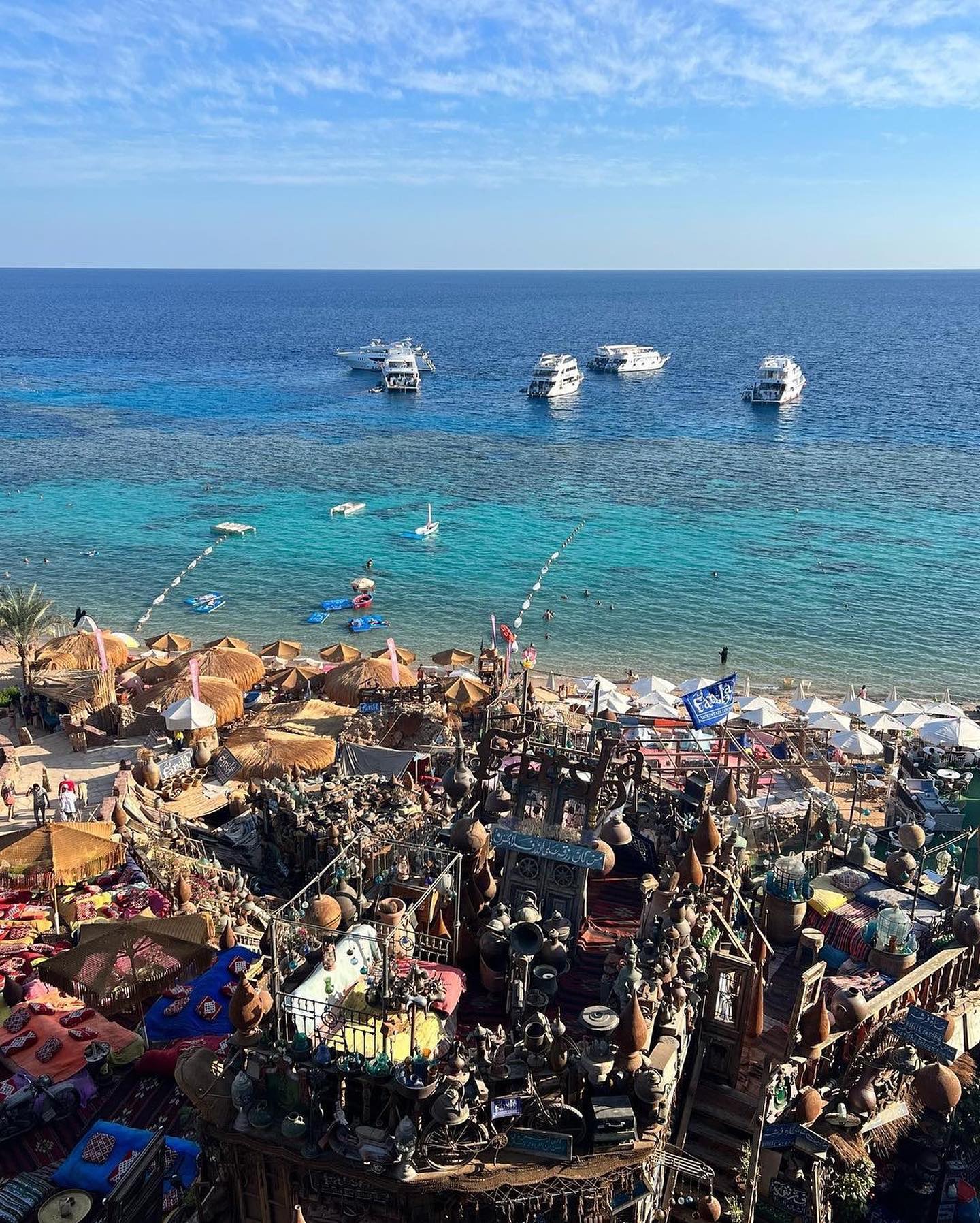 Farsha Café daytime cliffside terraces — traditional Bedouin seating overlooking the turquoise Red Sea