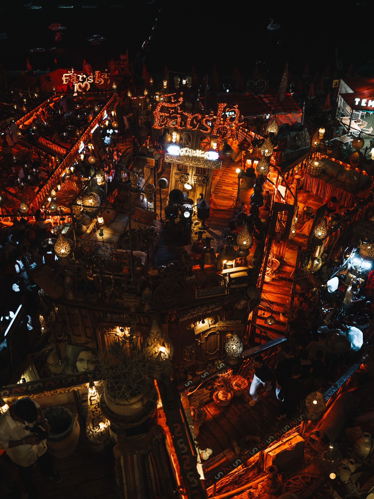 Farsha Café at night — hundreds of lanterns illuminating the multi-level cliffside terraces