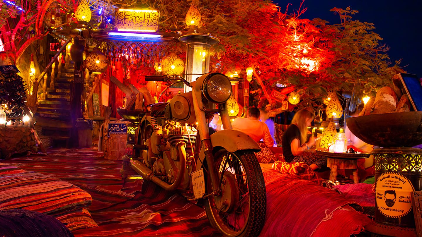 Detailed lantern and antique decorations at Farsha Café — handcrafted wooden and brass pieces creating a warm atmosphere